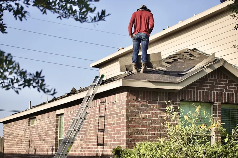 Professional roofer working on a residential roof in North Merrick